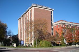 images of 100 Sims drive, a red brick 7 story building.